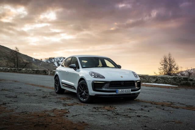 Porsche Macan parked on mountain road at sunset scenic wallpaper