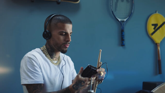 Rauw Alejandro Listening To Music With Headphones And Drums