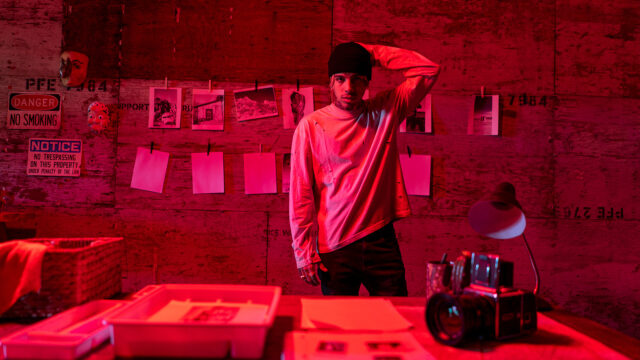 Rauw Alejandro Portrait In Red Room Ambiance