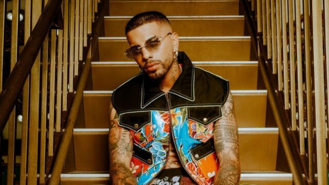 Rauw Alejandro Stylish Staircase Portrait Wallpaper