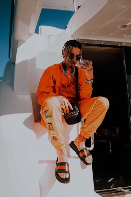 Rauw Alejandro Stylish Yacht Pose Wallpaper
