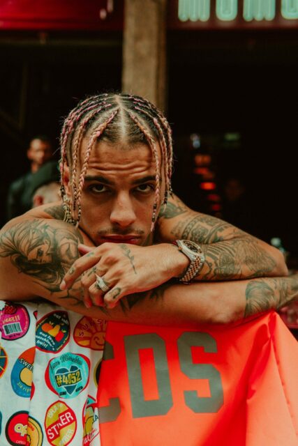 Rauw Alejandro Vibrant Style Wallpaper Tattoo And Braids