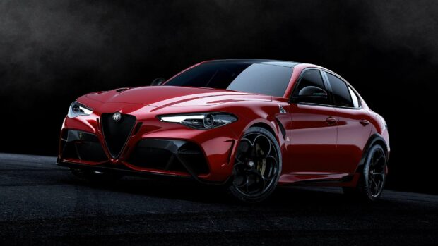 A red Alfa Romeo car is shown in a dark studio setting highlighting its sleek design, 2K Desktop Wallpaper
