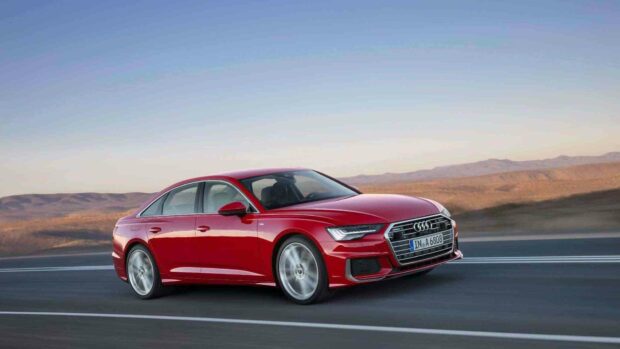 A red Audi A6 drives smoothly on a scenic highway with mountains in the background, HD Desktop Wallpaper