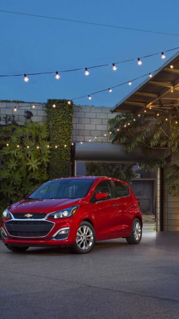 Red Chevrolet Spark In Outdoor Evening Setting Wallpaper