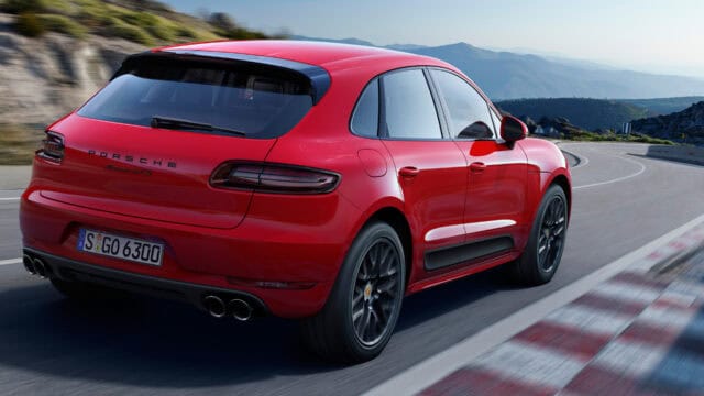 Red Porsche Macan GTS Driving on Mountain Road Wallpaper