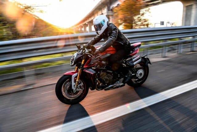 Rider speeding on red Mv Agusta Brutale 1000 motorcycle at sunset perfect wallpaper