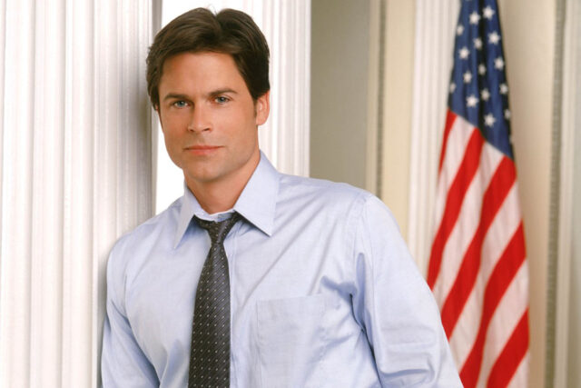 Rob Lowe as Sam Seaborn in The West Wing TV Series Wallpaper with American Flag Background