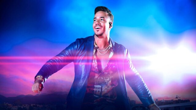 Romeo Santos Dynamic Performance Wallpaper in Vibrant Colors