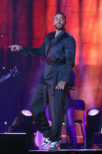 Romeo Santos Live Performance Wallpaper Vibrant Stage Background
