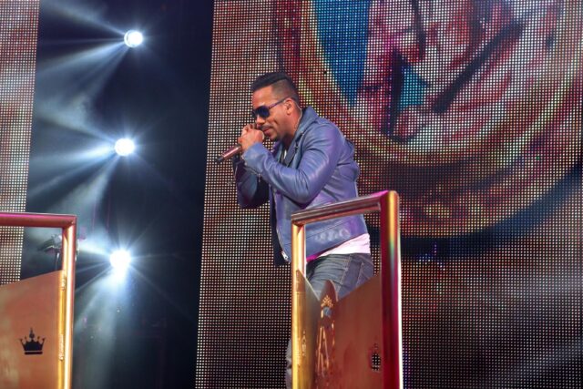 Romeo Santos Performing on Stage in Blue Jacket Wallpaper