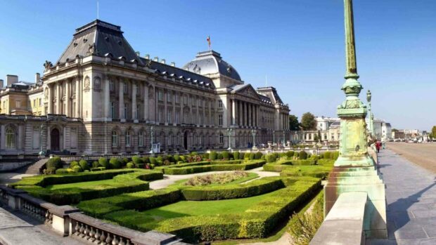 The royal palace and its manicured gardens are shown under a clear blue sky in Brussels, HD Desktop Wallpaper
