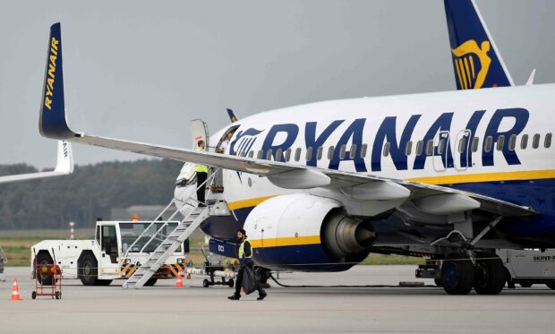 A Ryanair airplane is parked at the airport with ground crew around it preparing for boarding, 2K Desktop Wallpaper