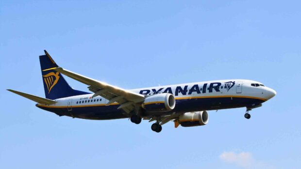 A Ryanair airplane is flying through a clear blue sky during the day, HD Desktop Wallpaper
