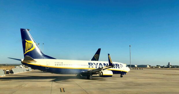 A Ryanair airplane is parked on the runway under a clear blue sky, 2K Desktop Wallpaper