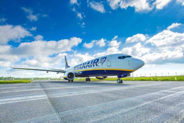 A Ryanair airplane is parked on the runway under a partly cloudy sky, HD Desktop Wallpaper