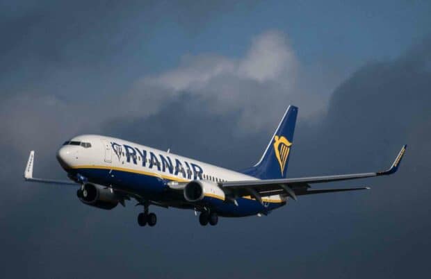 A Ryanair jet is captured mid flight against a cloudy sky, HD Desktop Wallpaper