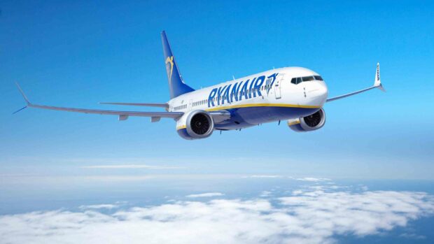 A Ryanair aircraft flying in a clear blue sky above the white clouds, 2K Desktop Wallpaper