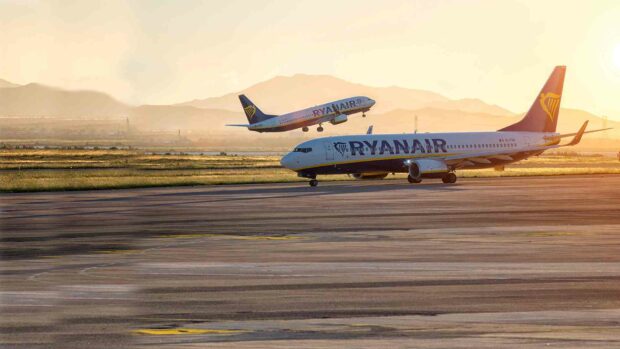 A Ryanair plane is taking off while another is taxiing on the runway during sunset, HD Desktop Wallpaper