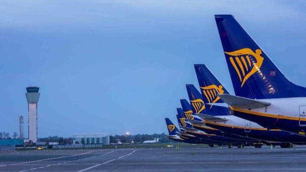 Ryanair planes are parked on the runway near the airport control tower during dusk, HD Desktop Wallpaper
