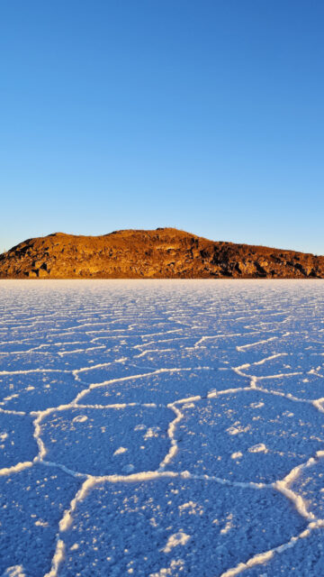 Salar De Uyuni Bolivia Salt Flats with Rocky Island under Clear Blue Sky Wallpaper