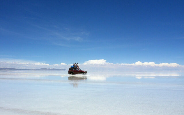 Salar De Uyuni Bolivia Stunning Reflection Landscape with Offroad Vehicle and Clear Blue Sky Wallpapers