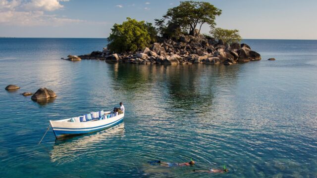 Scenic Lake Malawi View With Boat And Snorkelers Wallpaper