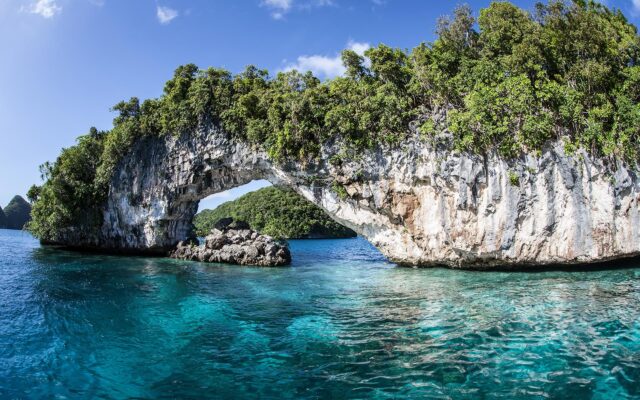 Scenic Natural Archway Over Blue Waters In Palau