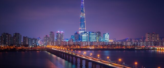 Seoul's Night Skyline Reflecting on Han River South Korea Wallpaper