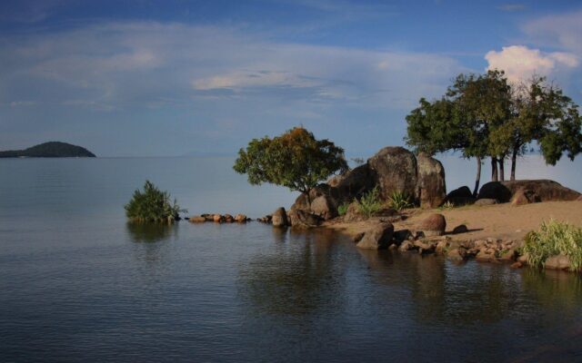 Serene Lake Malawi Scenery With Rocks And Trees Wallpaper