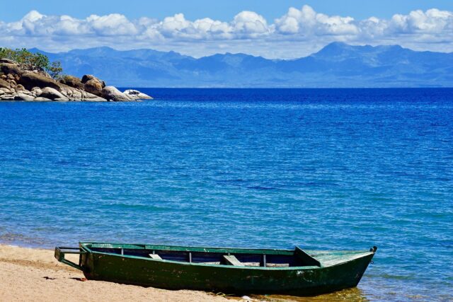 Serene Lake Malawi Shoreline With Boat Wallpaper