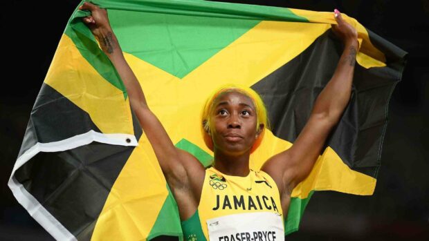 Shelly Ann Fraser Pryce holding the Jamaican flag after winning a race, 2K Desktop Wallpaper