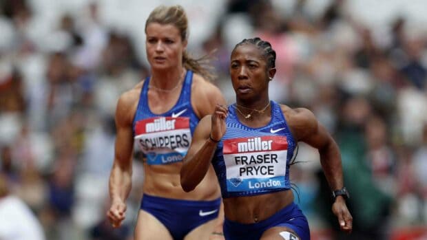 Shelly Ann Fraser Pryce is shown running fiercely in a race with another athlete during an outdoor event, 4K Desktop Wallpaper