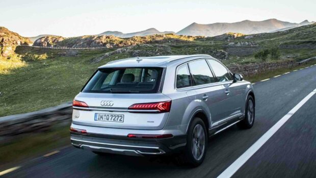 A silver Audi Q7 drives along a winding mountain road during daylight, HD Desktop Wallpaper