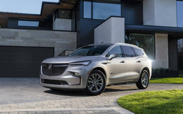 A silver Buick Enclave is parked on a driveway in front of a modern house with natural lighting, HD Desktop Wallpaper