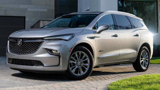 A silver Buick Enclave is parked on a driveway in front of a modern house under daylight, HD Desktop Wallpaper