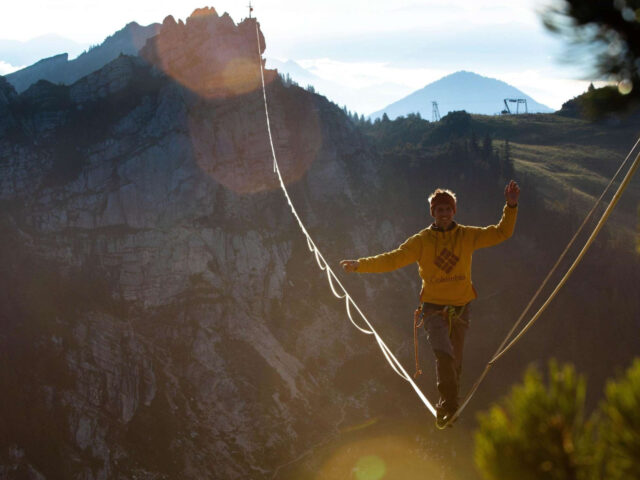 Slacklining Wallpapers Man Walking on Highline Above Mountain Landscape at Sunset