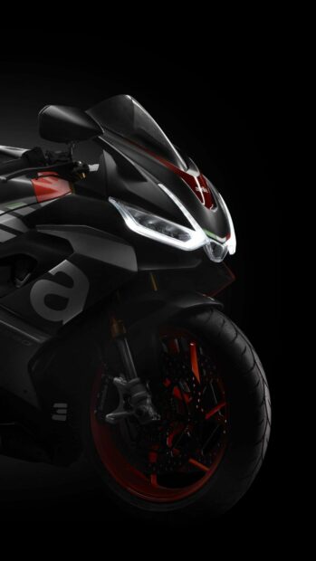 The image shows a sleek Aprilia motorcycle front view with illuminated headlights and detailed wheel, HD Phone Wallpaper