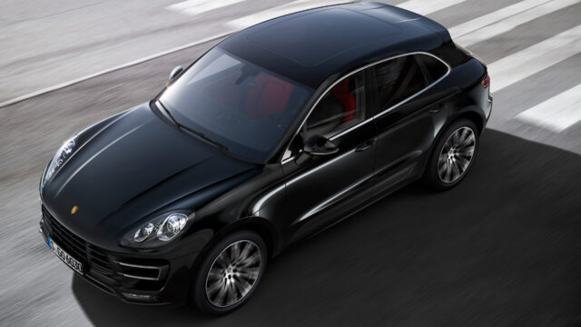 Sleek Black Porsche Macan Driving on Road High Quality Porsche Macan Wallpapers