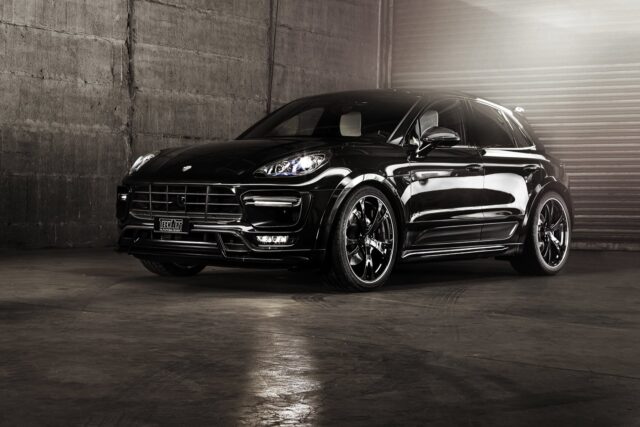 Sleek Black Porsche Macan SUV in Industrial Setting High Quality Car Wallpaper