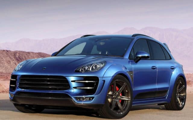 Sleek Blue Porsche Macan SUV Parked in Desert Landscape Wallpaper