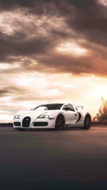 A white Bugatti Veyron is parked on an open road under a dramatic cloudy sky, HD Phone Wallpaper