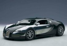A sleek Bugatti Veyron is parked in a studio with sharp lighting highlighting its design, 2K Desktop Wallpaper