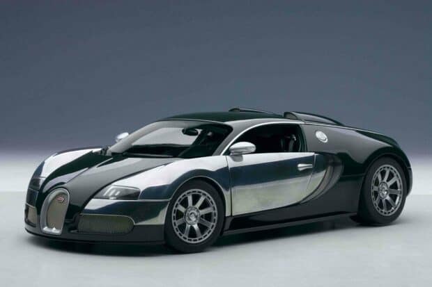 A sleek Bugatti Veyron is parked in a studio with sharp lighting highlighting its design, 2K Desktop Wallpaper