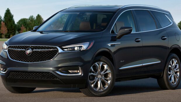 A black Buick Enclave is parked on a concrete surface with trees in the background, 4K Desktop Wallpaper