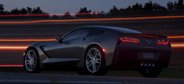 Sleek Chevrolet Corvette Sports Car Wallpaper With Night Light Trails Background