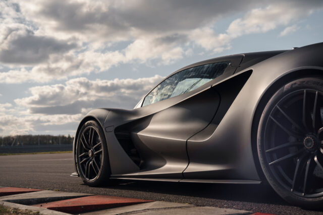 Sleek Lotus Evija Wallpaper Featuring Matte Black Hypercar On Race Track