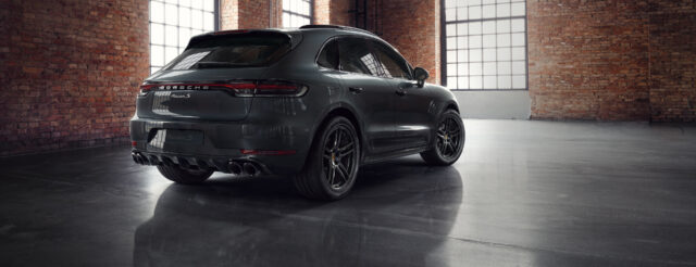 Sleek Porsche Macan S Rear View Wallpaper in Industrial Loft Setting