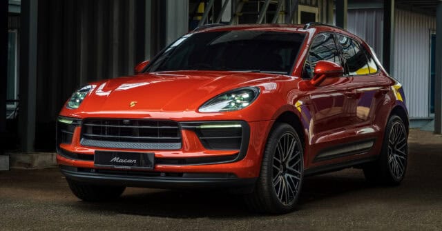 Sleek Red Porsche Macan SUV Parked in Urban Setting High Quality Wallpaper