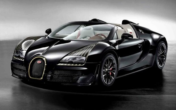 A sleek black Bugatti Veyron with gold accents is shown in a studio, HD Desktop Wallpaper